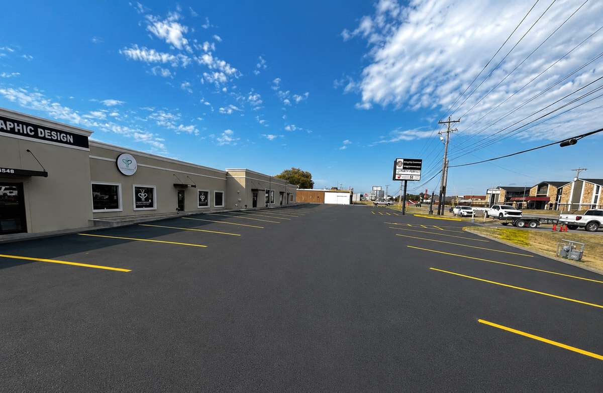 Freshly resurfaced and striped multi-tenant commercial building parking lot in Tulsa, Oklahoma by Kingdom Paving
