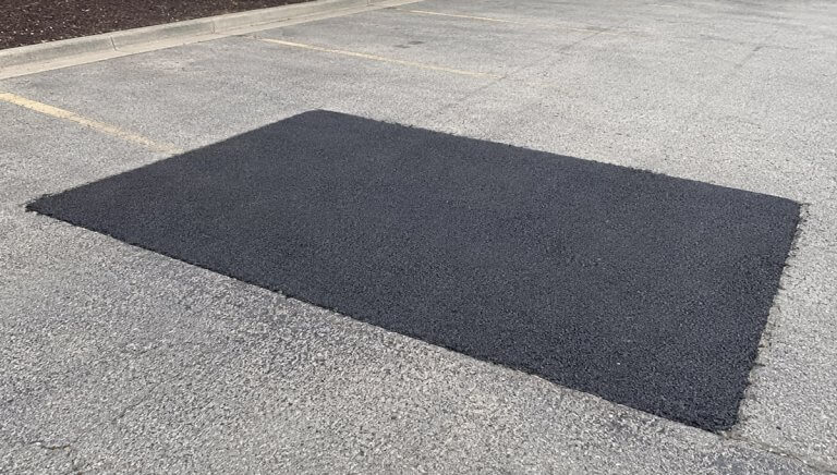 Asphalt repair and patching for a damaged parking lot