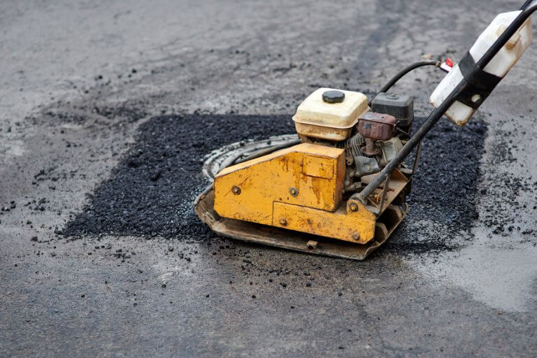 Pothole repair for a damaged asphalt parking lot