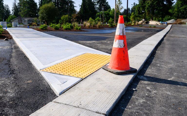 Sidewalks, curbs, and concrete pads installed for a property